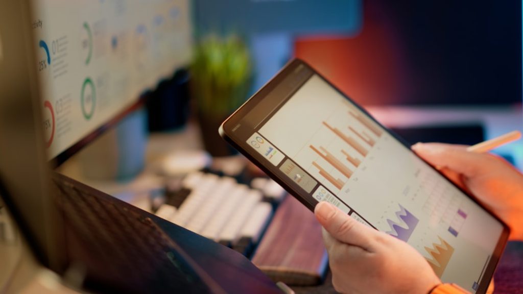 Someone analyzes financial data on a tablet